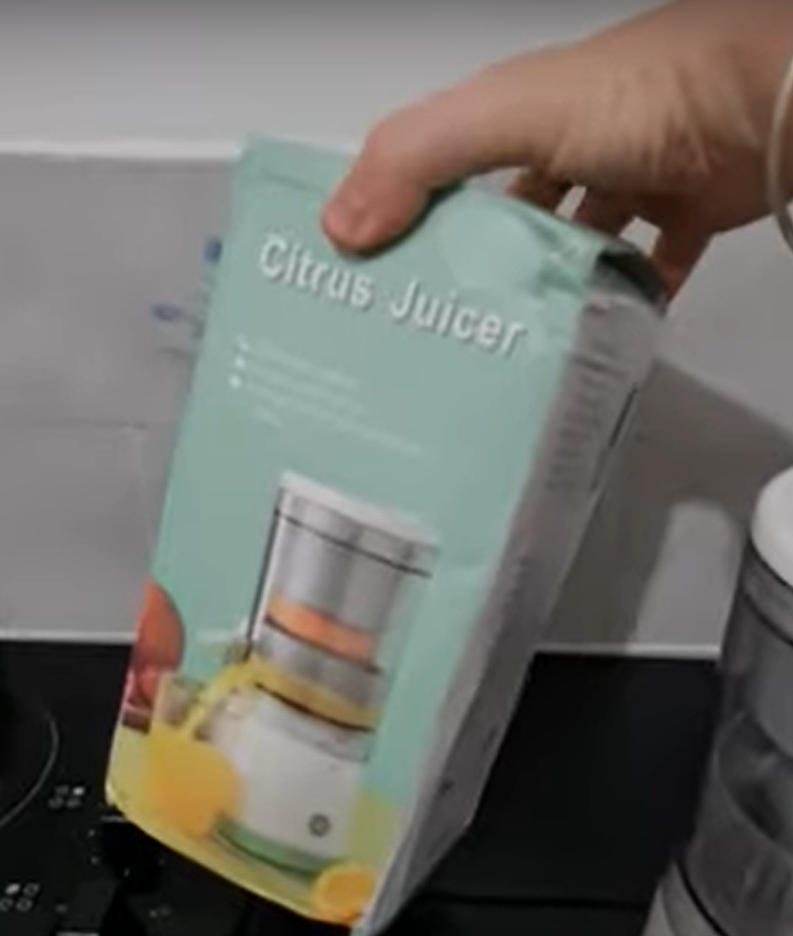 Hand holding CitrusJuicer's box